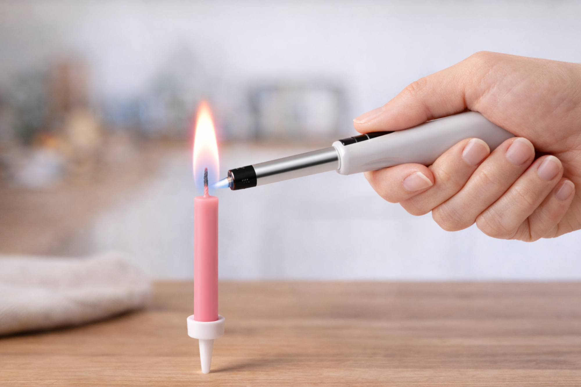 Lighting a pink birthday candle on cake with lighter